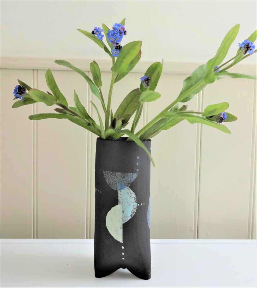 Stevie.  Unusual black ceramic 3-legged vase with abstract pastel motifs