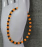 UV Reactive Orange Glass and Dark Metal Bead Elastic Bracelet - Image 2