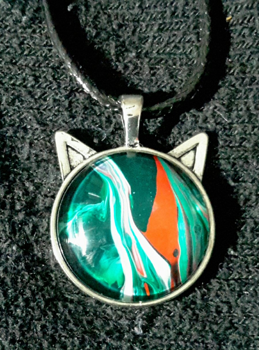 Unique handmade fluid art green and red cat face pendant.