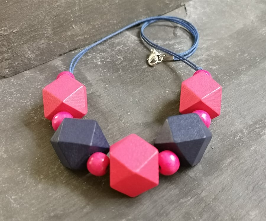 Necklace with navy blue and fuchsia pink wooden geometric beads