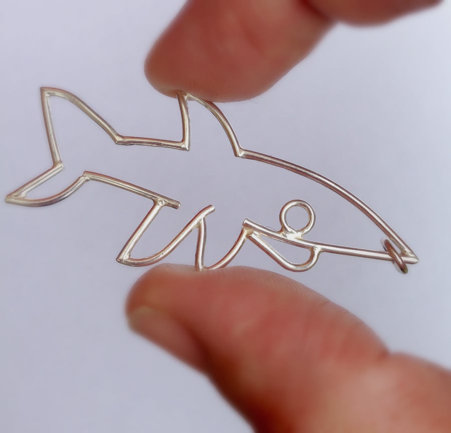 A chunky sterling silver shark designed from a child drawing.