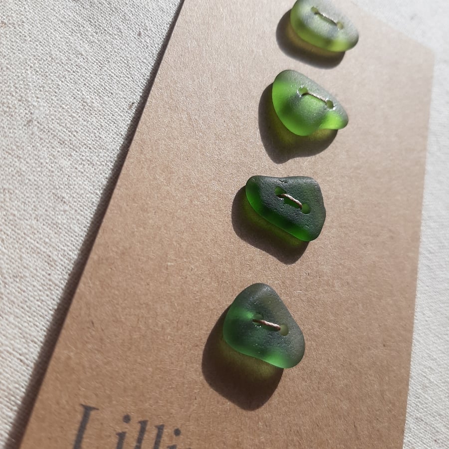 Four sea glass buttons in shades of green