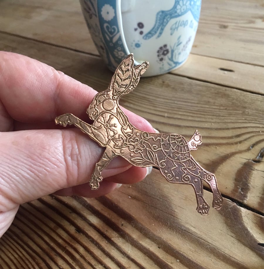 Leaping hare brooch pin made from copper.