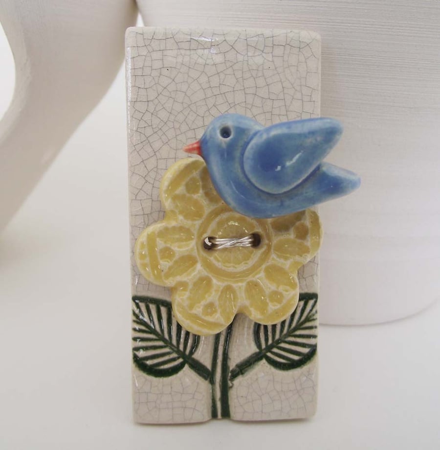 ceramic bird brooch with flower button