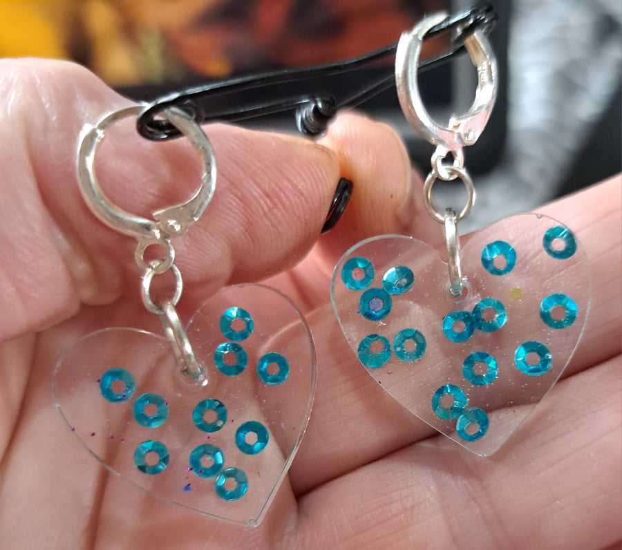 Heart shaped pair of resin with blue sequins