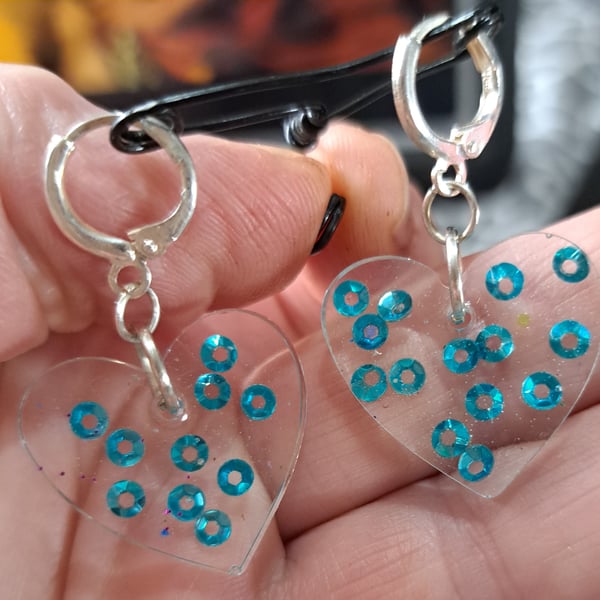 Heart shaped pair of resin with blue sequins