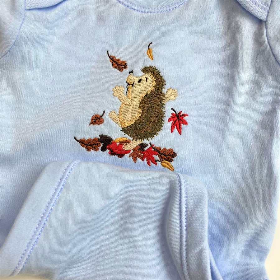 Baby Long Sleeved Body Suit 0 - 3 months in blue with hedgehog embroidery