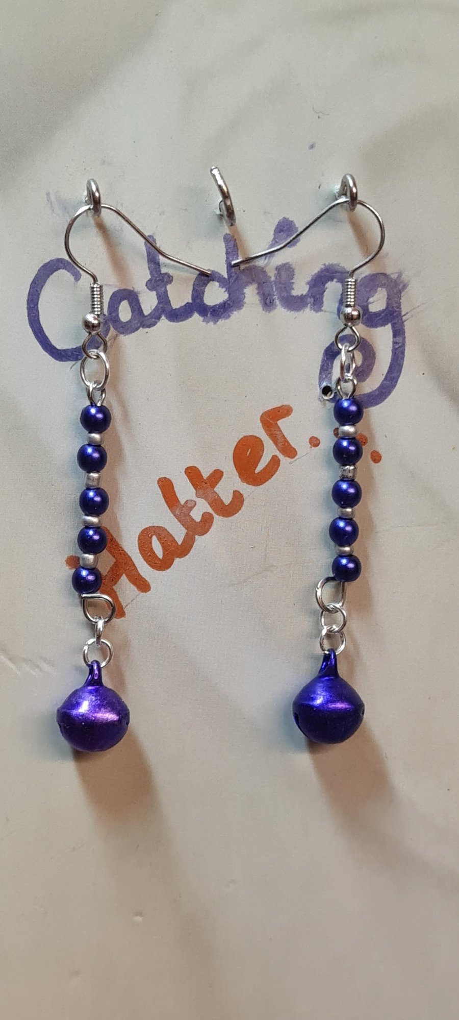 Purple and silver beaded earrings with real bells.