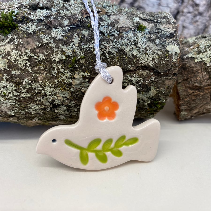 Teeny ceramic dove decoration with leaves and orange flower