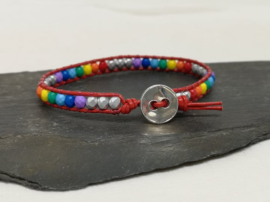 Multicoloured rainbow bead and red leather bracelet with button fastener 