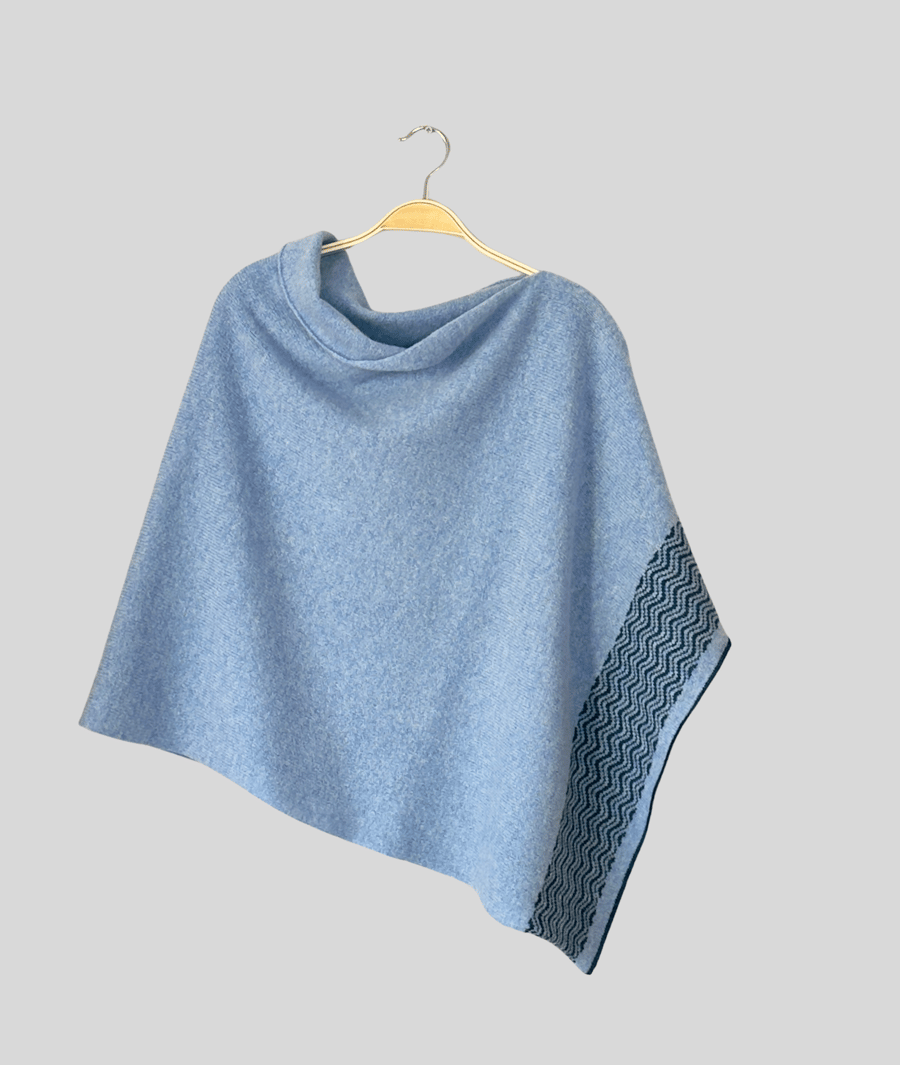 Poncho soft merino lambswool light blue with wavy petrol blue border