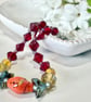 Slender glass bead bracelet in earthy shades of red and orange.  - Image 5