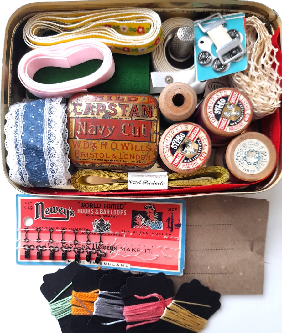 Vintage sewing haberdashery kit in an old metal sweet tin