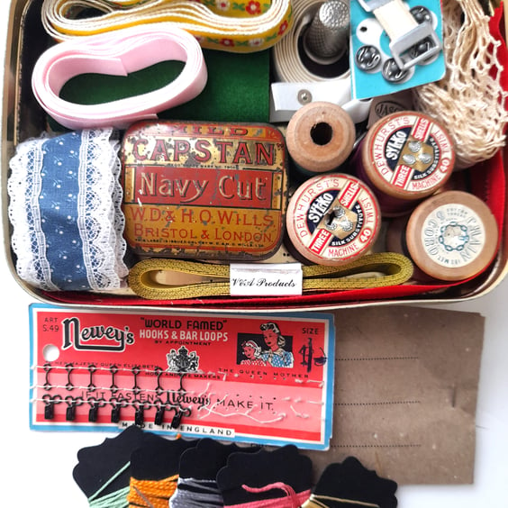 Vintage sewing haberdashery kit in an old metal sweet tin