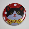 LITTLE BLACK AND WHITE CAT ON RED BADGE