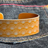 Geometric shell pattern cuff bracelet yellow orange