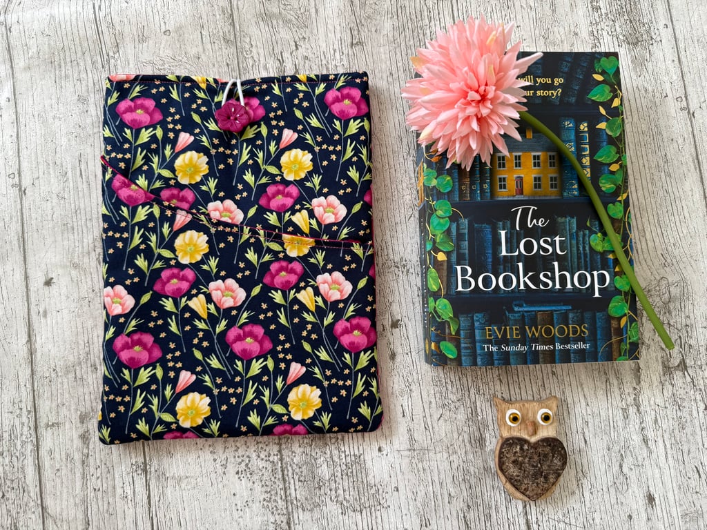 Fabric book sleeve with pocket for paperback books. Padded and fully lined.