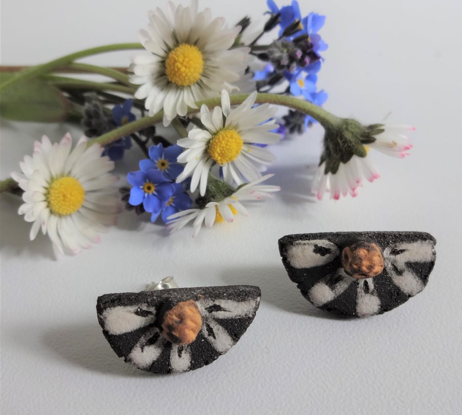 Handmade daisy stud ceramic earrings with sterling silver fittings.