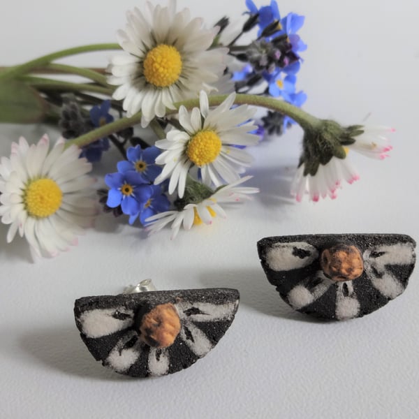Handmade daisy stud ceramic earrings with sterling silver fittings.