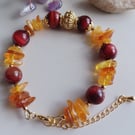 Cat's eye and amber beaded bracelet with golden plated adjustable chain