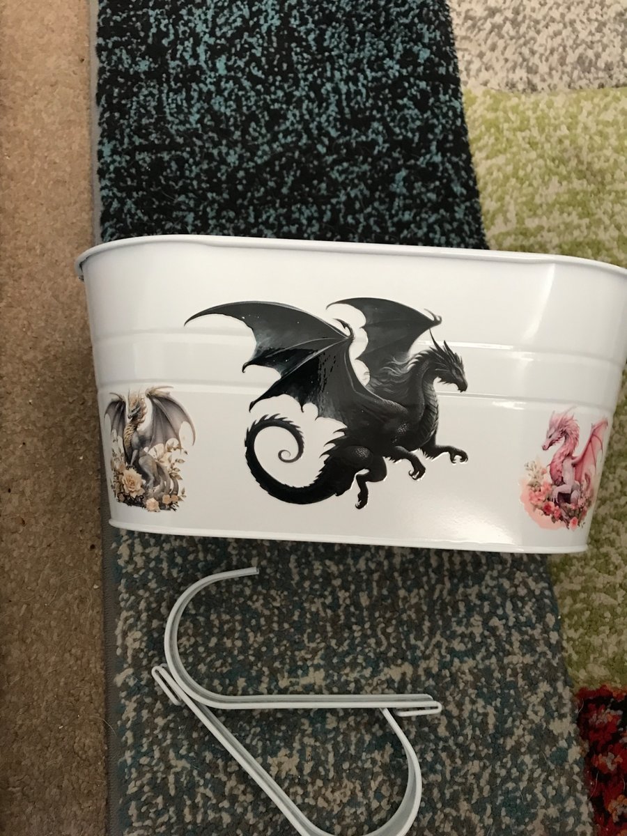 White fence planter with dragon motif 
