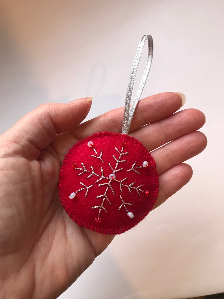 Hand embroidered red felt Christmas decoration.