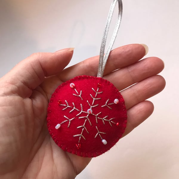 Hand embroidered red felt Christmas decoration.