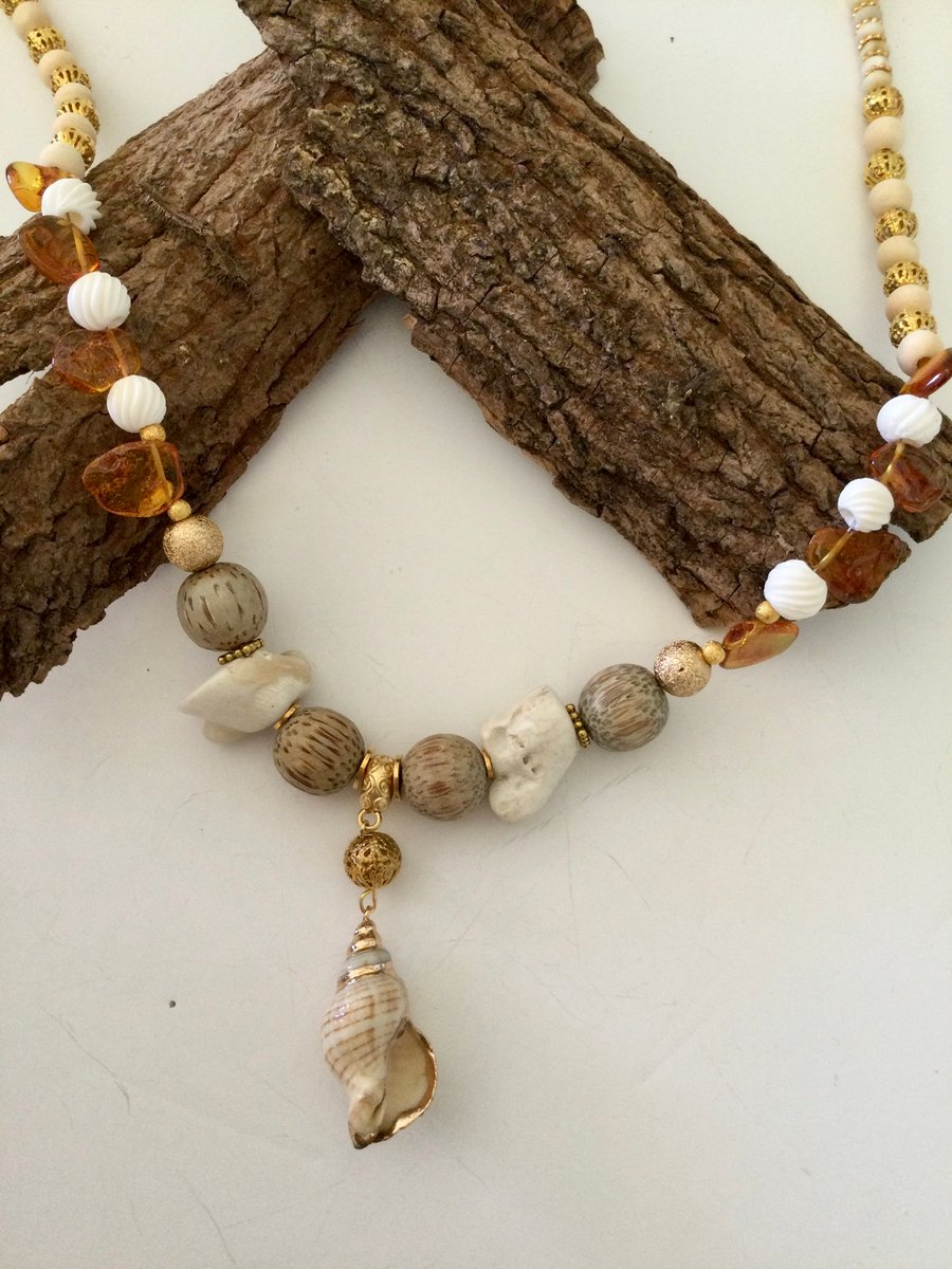 Cream and gold coral and shell pendant necklace, amber, bone and sandalwood