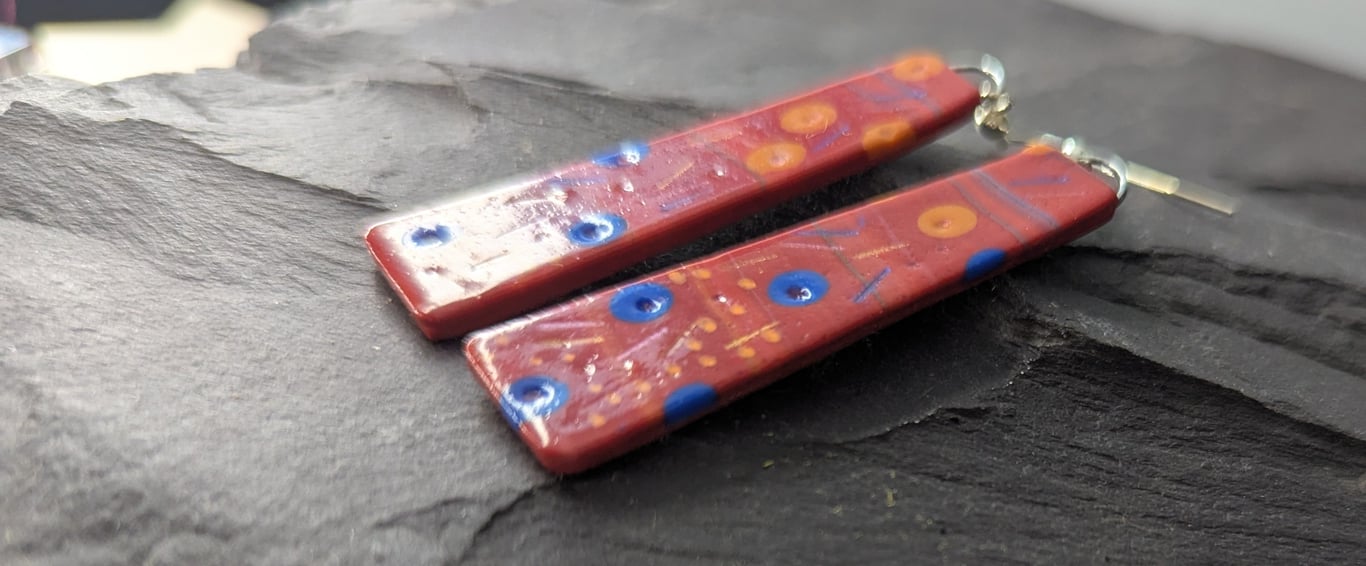 Red drop earrings with bold dot and dash pattern