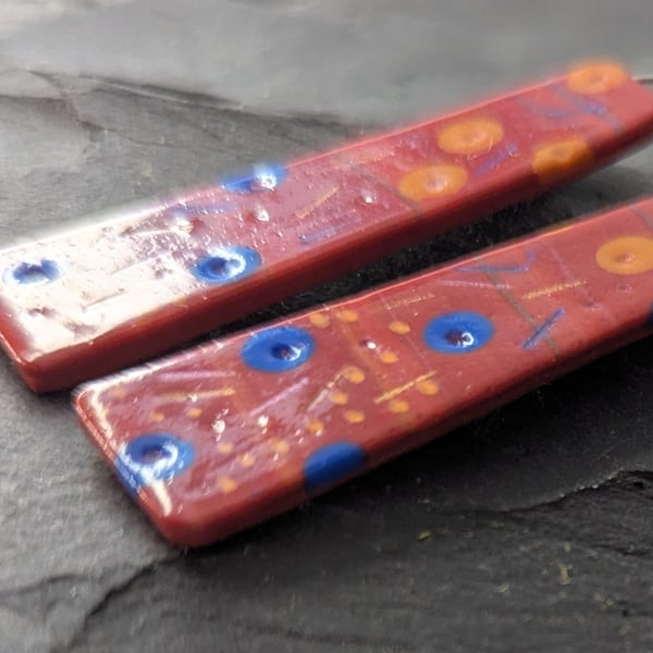 Red drop earrings with bold dot and dash pattern