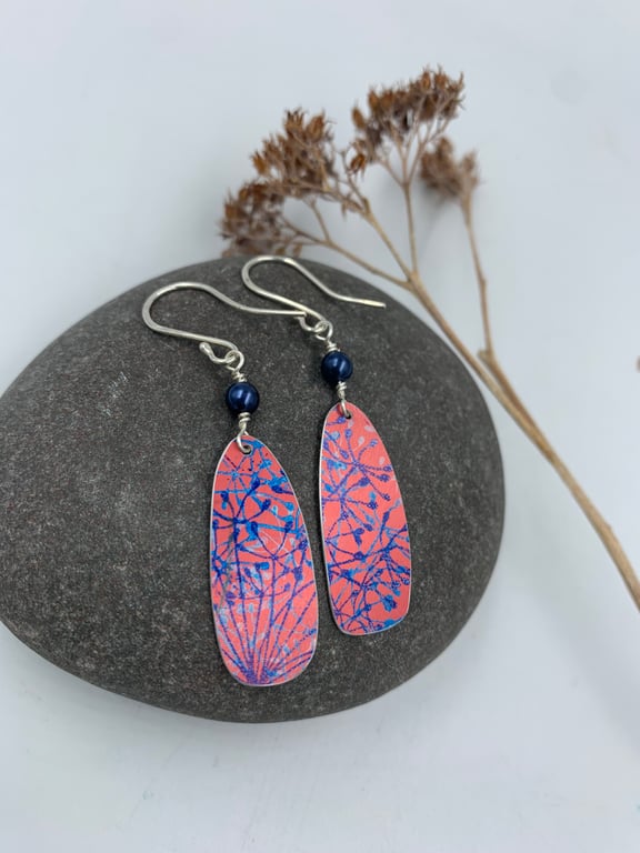 Red aluminium cow parsley drop earrings with blue bead