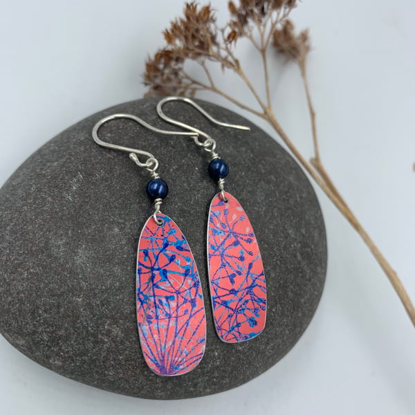 Red aluminium cow parsley drop earrings with blue bead