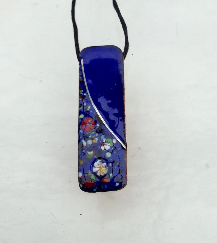SMALL, SLIM, OBLONG FLORAL ENAMELLED PENDANT WITH STERLING SILVER DESIGN