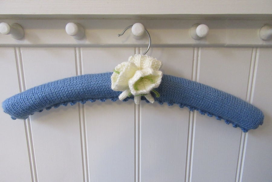 Knitted coat hanger with  a posy of white crocus