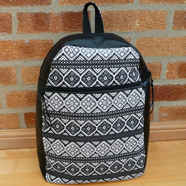 Black vinyl backpack with grey, black & white feature front panel and zip pocket
