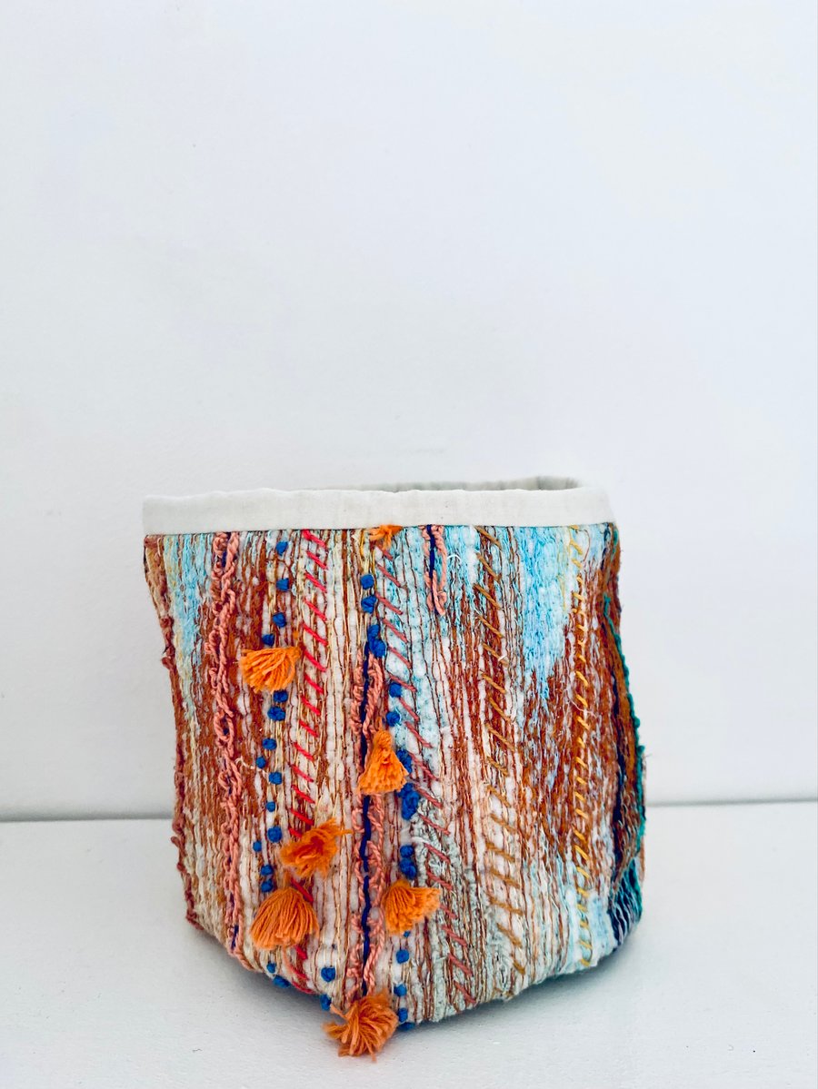 Colourful storage container or pot plant holder