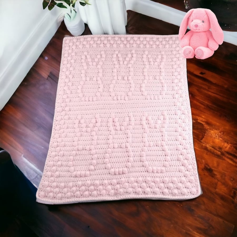 Crochet baby blanket in pink with puff bobbly bunny pattern