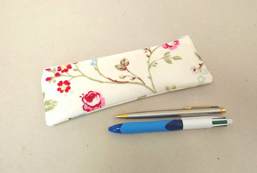 Pencil case in cream with pink, blue and red flowers, wipe clean oilcloth