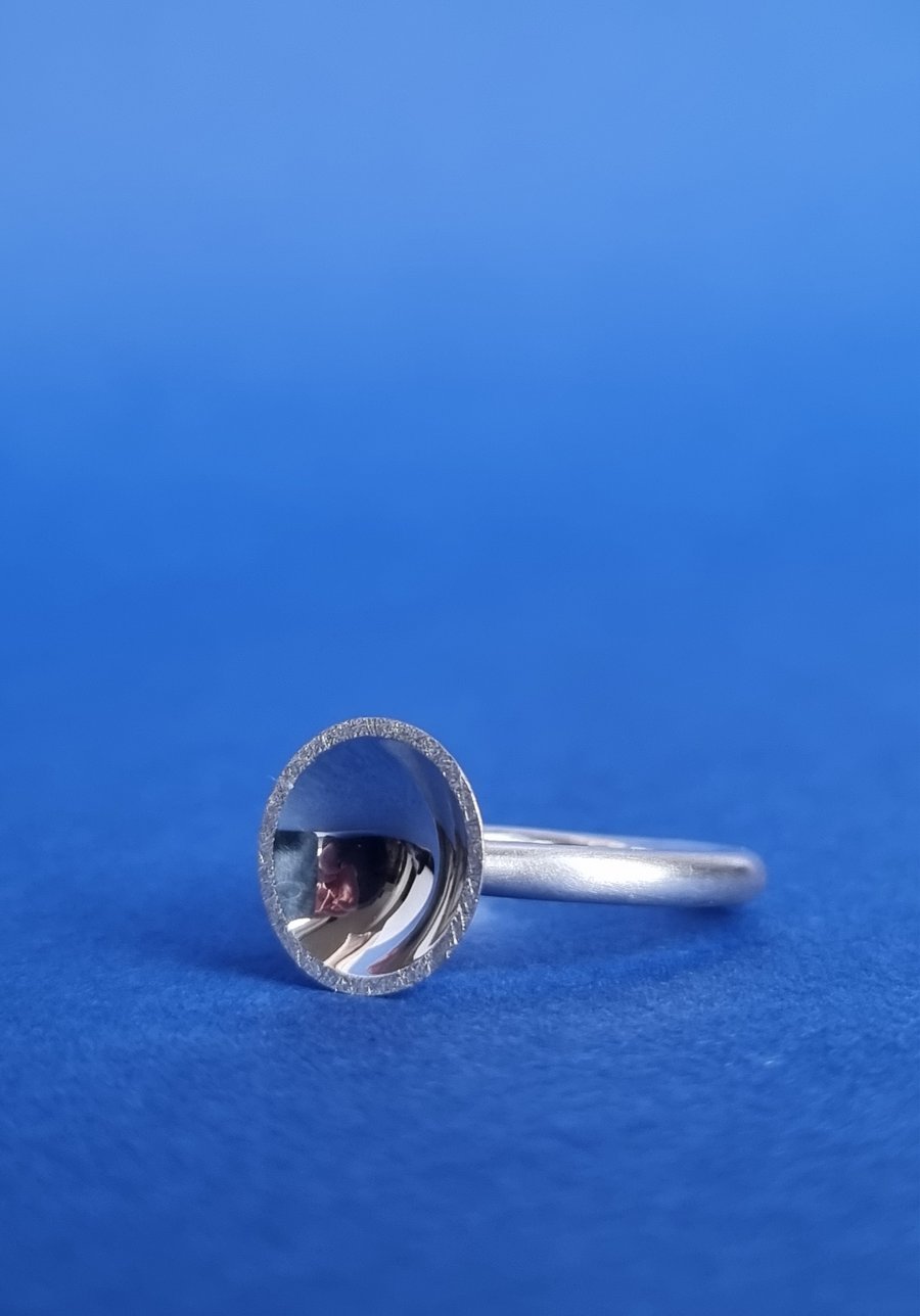 Sterling silver polished concave dome ring.