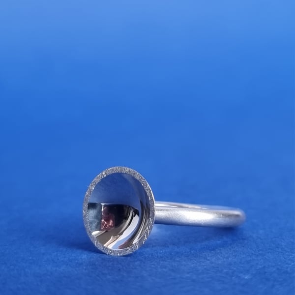 Sterling silver polished concave dome ring.