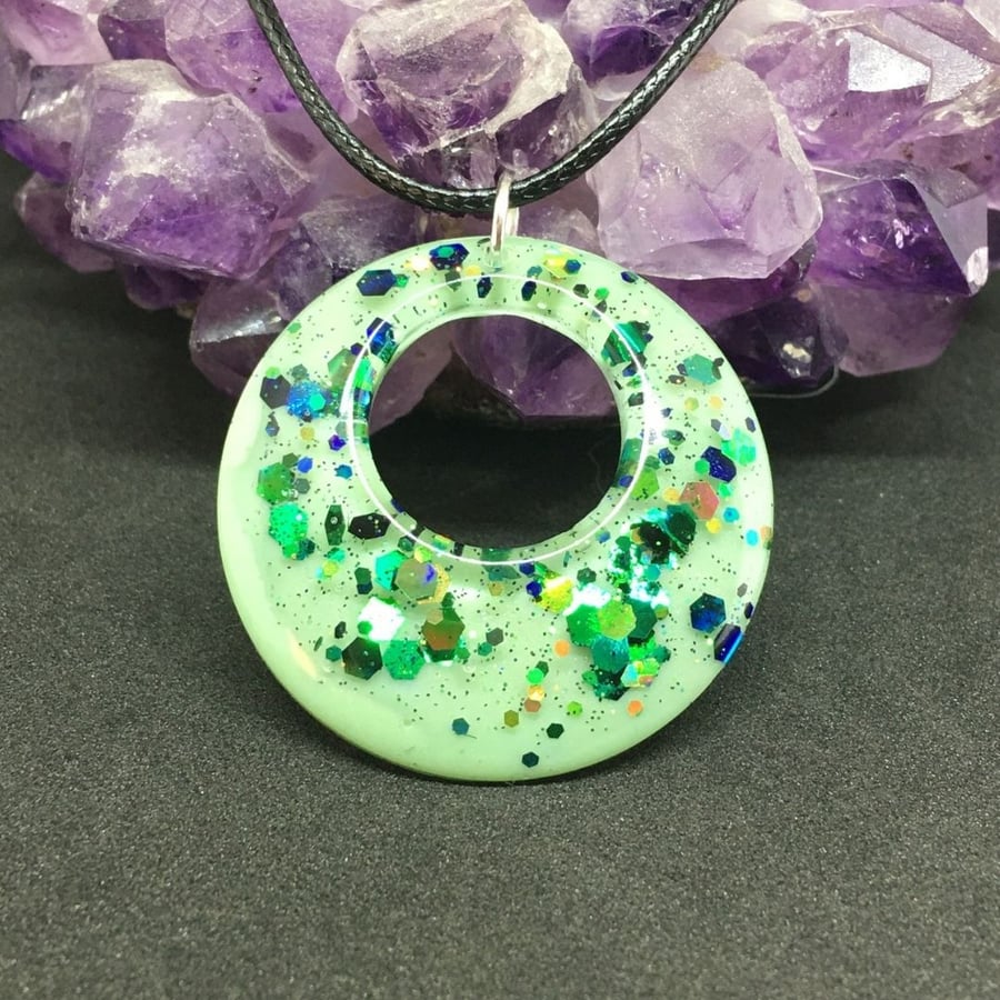 Spring green sparkly donut necklace encased in resin.