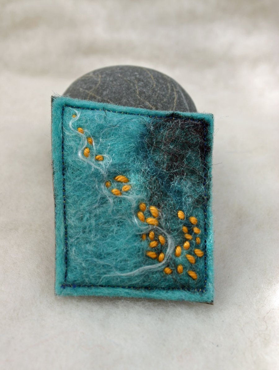 Felted hand made brooch with orange stitch 