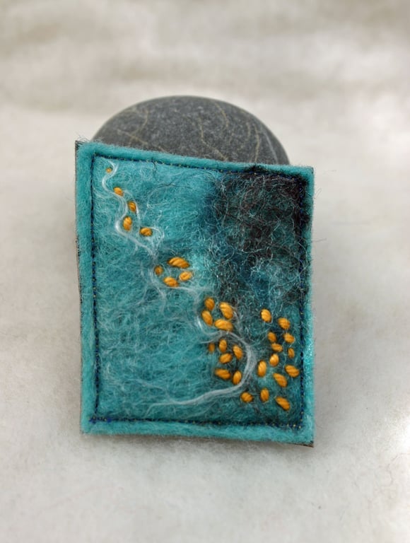 Felted hand made brooch with orange stitch 