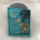 Felted hand made brooch with orange stitch 