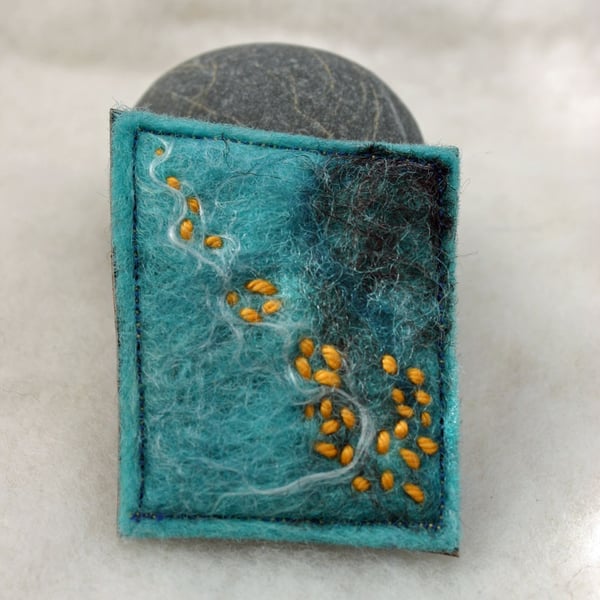 Felted hand made brooch with orange stitch 