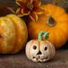 Ceramic pumpkin decoration with carved face Jack o lantern