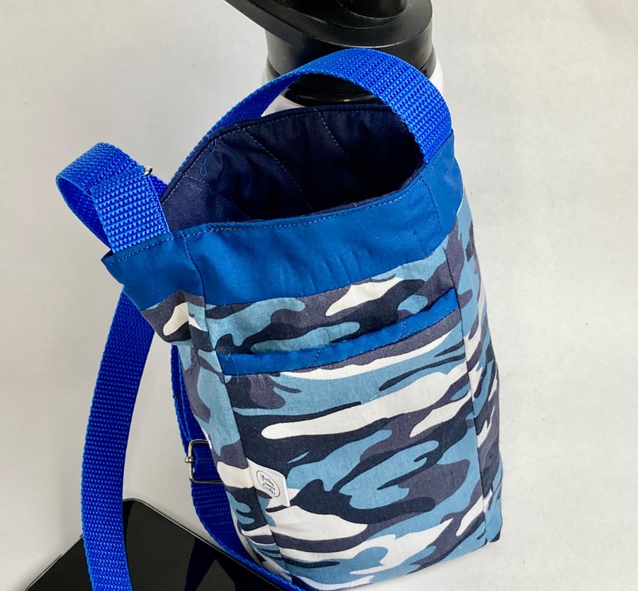 Water bottle carrier with key clip and pocket for phone. Blue camo fabric.