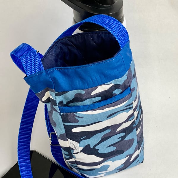 Water bottle carrier with key clip and pocket for phone. Blue camo fabric.