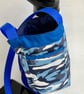 Water bottle carrier with key clip and pocket for phone. Blue camo fabric.