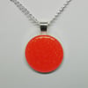 Round orange glittered epoxy pendant 